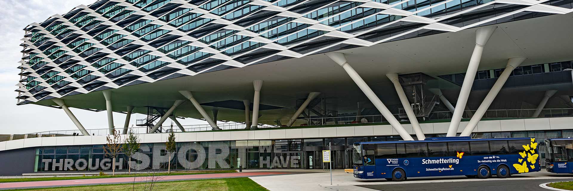 Schmetterling Reisen bus in front of adidas headquarters